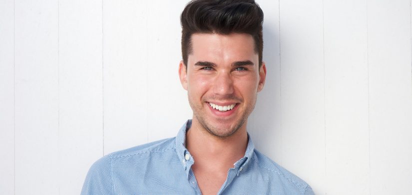 young man smiling outdoors