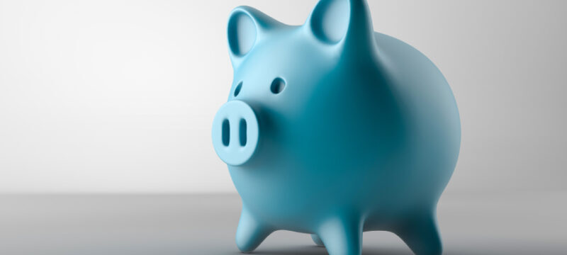 A blue piggy bank on a gray background