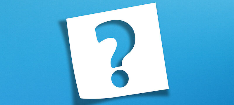 Blue question mark on a white note paper against a blue background