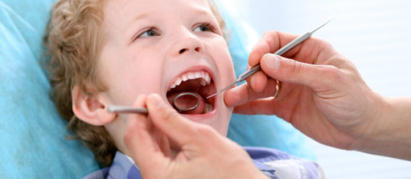 young boy getting dental sealants at the dentist